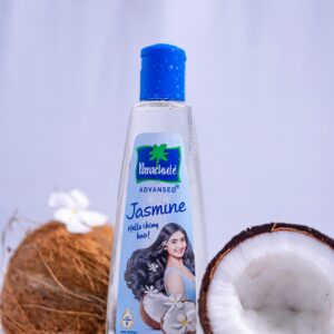 Parachute Jasmine hair oil bottle with coconuts and jasmine flowers, promoting shine and fragrance.